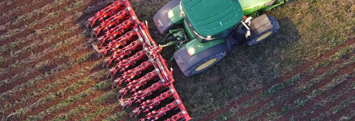 view from above of a strip till machinery working in a field at night